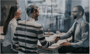 Young couple meeting with financial advisor in private meeting room