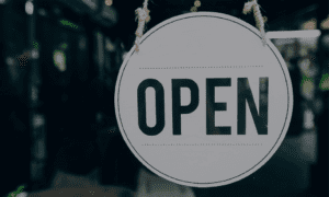 Open sign hanging in business window