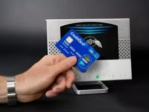 Image of person tapping credit card to make a payment