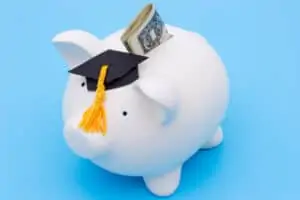 Piggy bank with graduation cap and money
