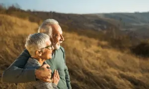 Older couple on hill looking at the horizon