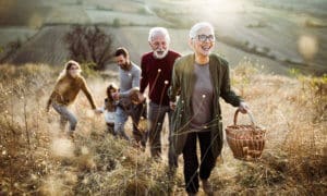 extended family walking up hill smiling