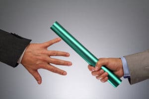 business men passing a running baton