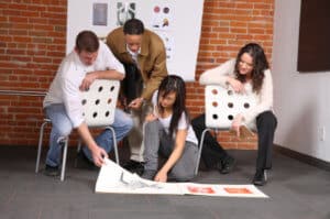 People gathered around looking at designs