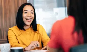 Business woman smiling while meeting with a client