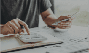 Person using calculator to add up financials
