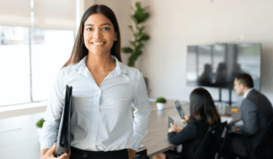 Business women holding portfolio looking at camera