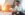 Business man sitting on stairs outside on tablet smiling at sunset