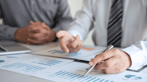 men at work looking over graphs - investment strategies