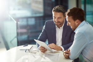 Two men sitting at a table in a business meeting