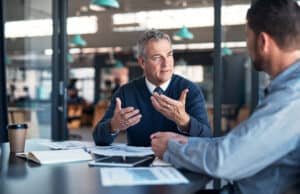 Two men in a business meeting - leverage commercial property